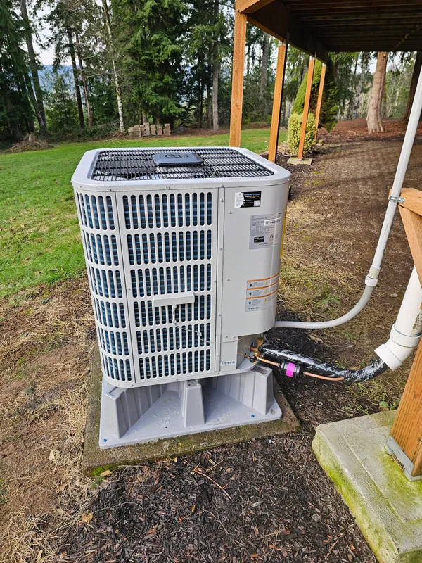 Bosch heat pump outdoor unit installed under a pergola at a Washington home