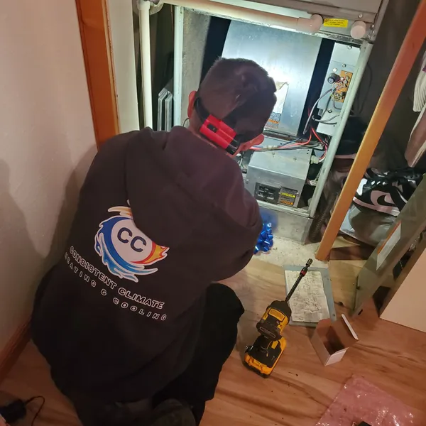 Nathen Scott, owner of Consistent Climate, working on a furnace installation